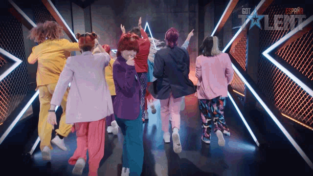 a group of people are dancing in front of a sign that says got talent on it