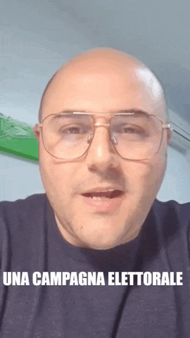 a bald man wearing glasses and a black shirt says una campagna elettoriale