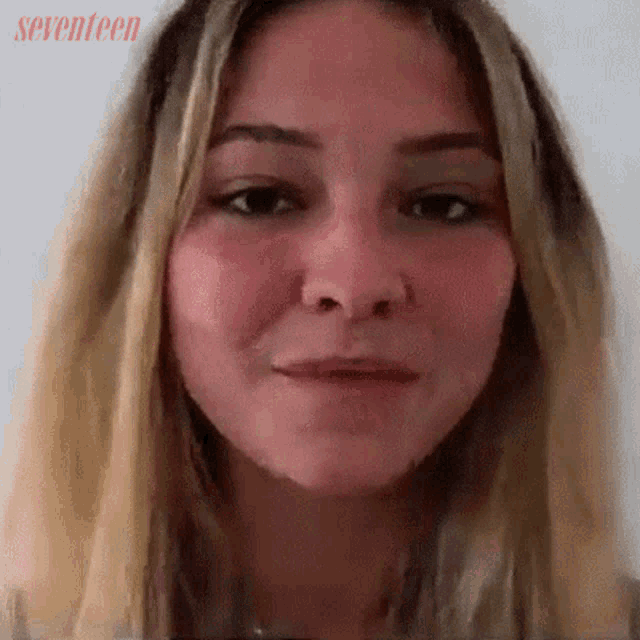 a close up of a woman 's face with seventeen written on the bottom right