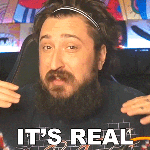 a man with a beard is wearing a headband and says it 's real