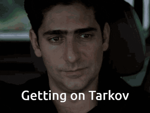 a man sitting in a car with the words " getting on tarkov " on the screen
