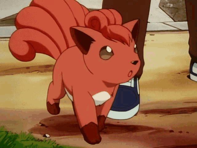 a red cartoon cat is standing next to a person 's foot