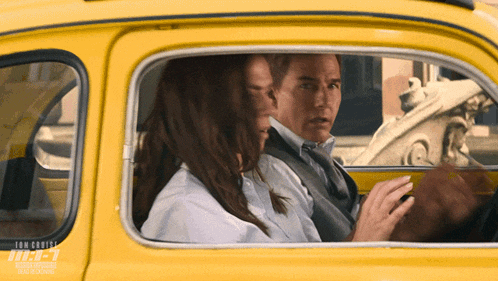 a man and a woman are sitting in a yellow car with the word tom cruise on the bottom