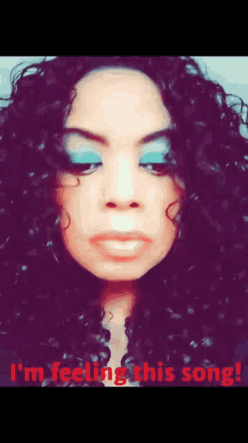 a close up of a woman 's face with the words i 'm feeling this song below it