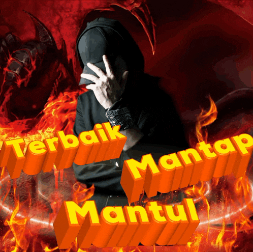 a man in a black hoodie is covering his face in front of a fire and the words terbaik mantap mantul