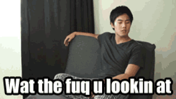 a man sitting on a couch with the words wat the fuq u lookin at