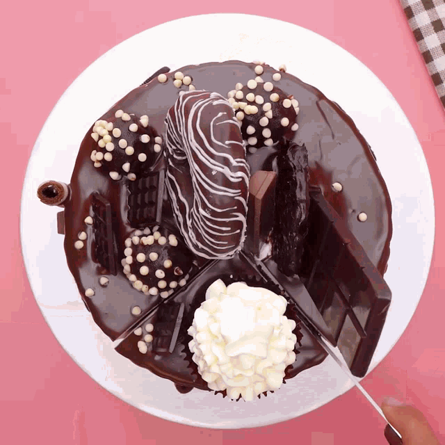 a white plate topped with a chocolate cake with whipped cream