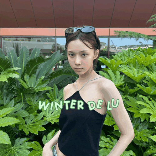 a woman wearing sunglasses and a black top with the words winter de lu