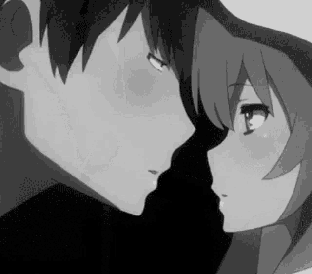 a boy and a girl are kissing in a black and white anime scene .