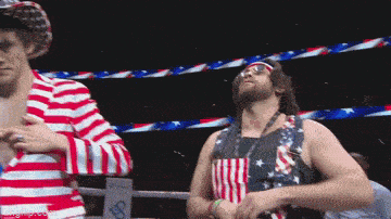 a man in an american flag outfit stands next to another man in a striped jacket