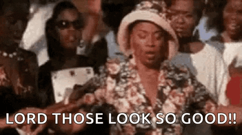 a woman is standing in front of a crowd of people and saying `` lord those look so good '' .