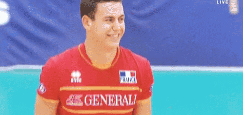 a man wearing a red shirt with the word general on it .