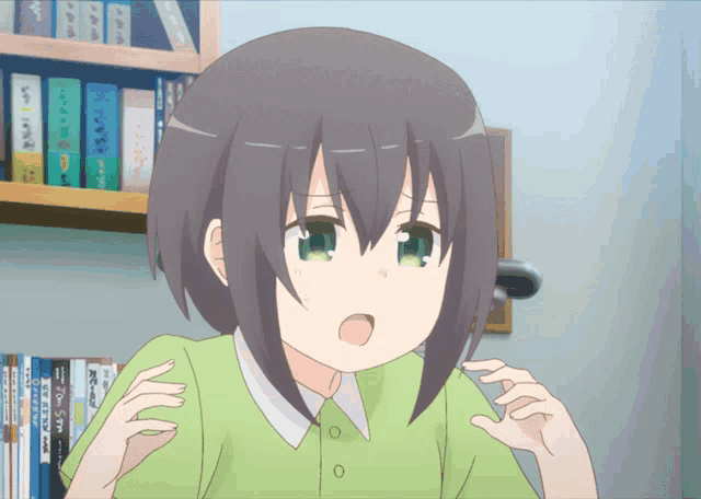 a girl in a green shirt is looking at something