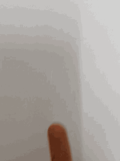 a close up of a person 's finger on a white background