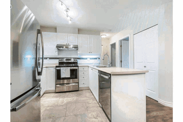 a kitchen with stainless steel appliances including a dishwasher