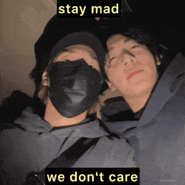 two men wearing face masks with the words stay mad we don 't care