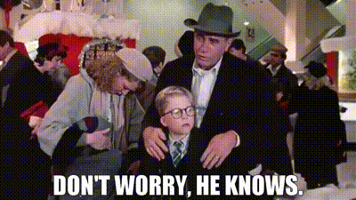 a man and a woman are standing next to a little boy in a crowd of people .