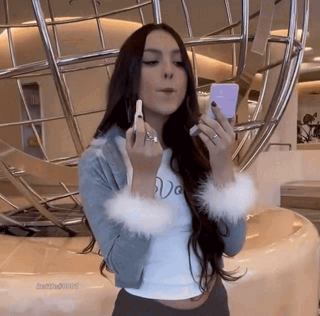 a woman smoking a cigarette and holding a cell phone with the hashtag justme20001 on the bottom right corner