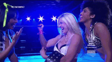 three women are standing in a wrestling ring and one of them is wearing a leopard print top