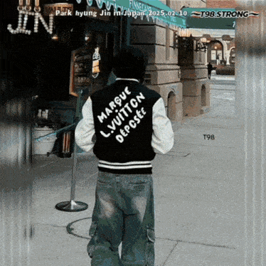 a person wearing a jacket that says marque lv vuitton deposee on it