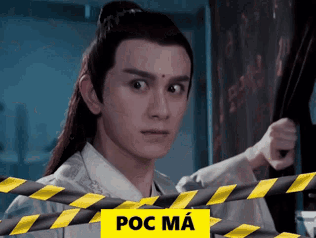 a man is behind a yellow and black striped tape with the word poc on it