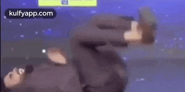 a person is laying on their back in a video game and playing a video game .