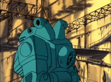 a blue robot is standing in a building with a shadow on the wall