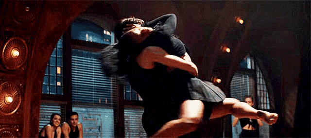 a man and a woman are dancing together on a dance floor .