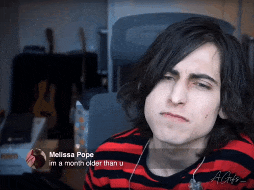 a young man in a red and black striped shirt is talking to melissa pope