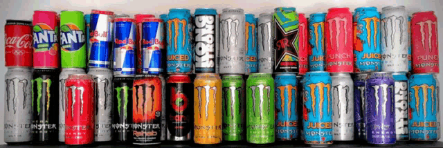 several cans of monster energy drinks are lined up on a table