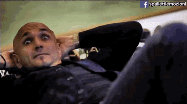 a man is laying on his stomach with a facebook logo in the corner