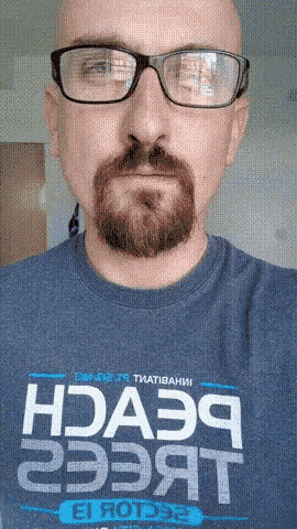 a bald man with glasses and a beard is wearing a shirt that says hda39