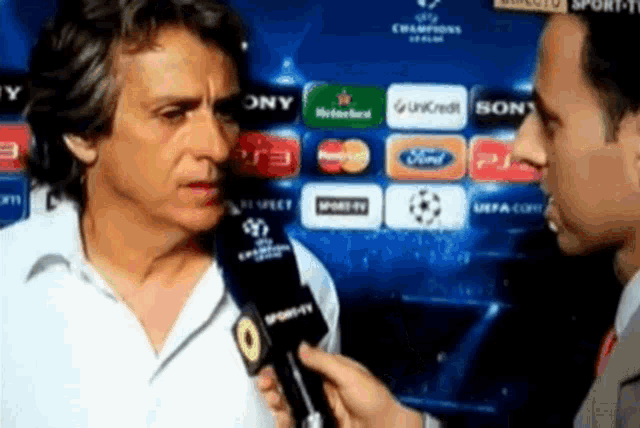a man is being interviewed by a sports tv presenter