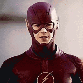 a close up of a man in a flash costume looking at the camera .