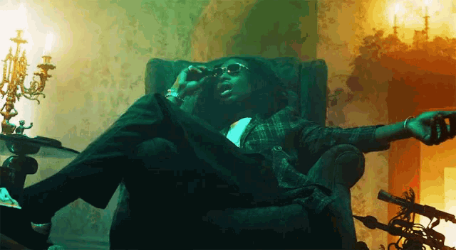 a man sits in a chair with his legs crossed