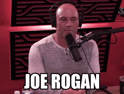 a man wearing headphones is sitting in front of a microphone and the name joe rogan is displayed above him