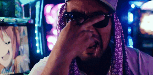a man wearing sunglasses and a scarf covering his face