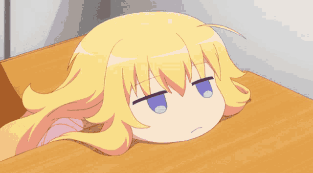 a little girl with blonde hair and blue eyes is laying on a table