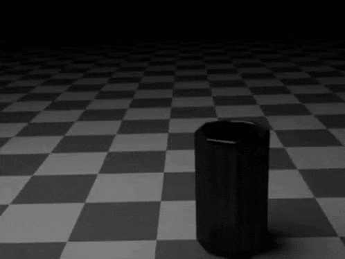 a black cylinder is sitting on a checkered floor next to a person .