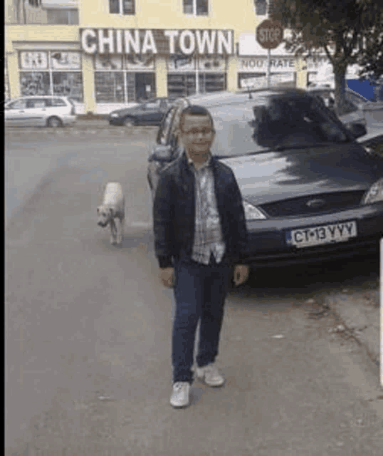 a man and a dog are standing in front of a china town restaurant