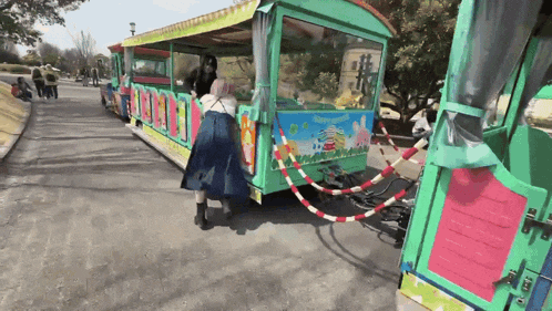 a colorful train with a sign that says ' snoopy ' on it