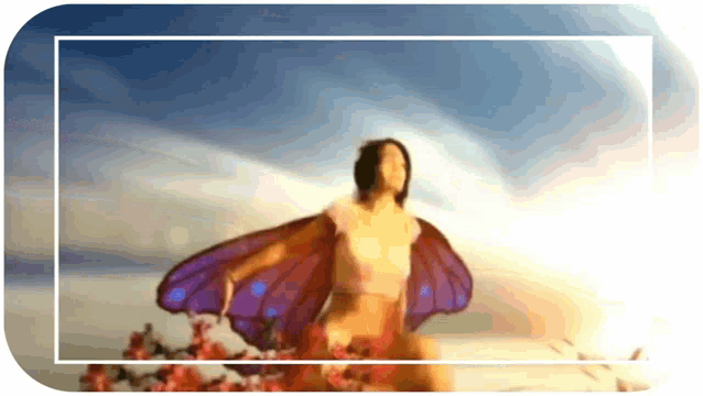 a woman with butterfly wings stands in front of flowers