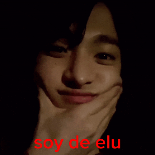 a close up of a person 's face with the words soy de elu written in red