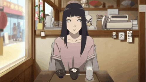 a girl is sitting at a table with two bowls of food on it