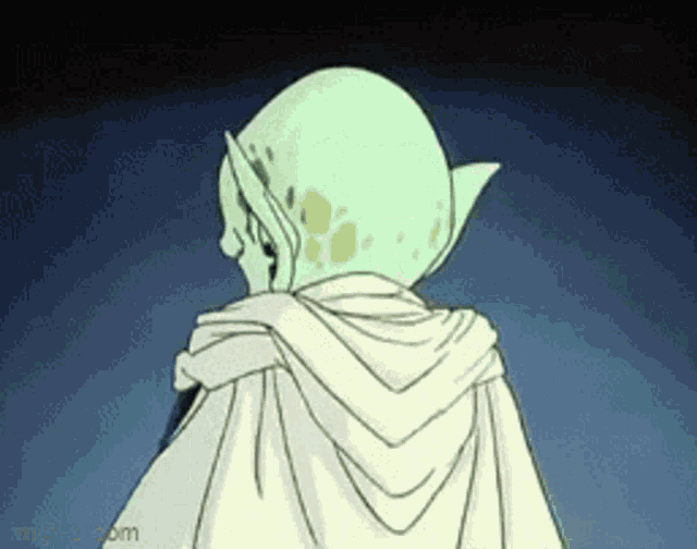 a cartoon character with green hair and a white cape is standing in the dark .