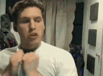 a man wearing a white shirt and tie is adjusting his tie