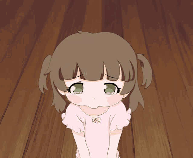 a girl with brown hair and green eyes is wearing a pink shirt with a bow on it