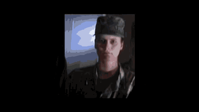 a close up of a soldier 's face with a hat on