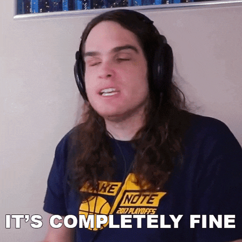 a man wearing headphones and a shirt that says take note