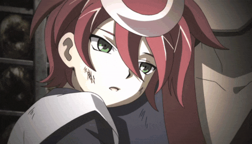 a girl with red hair and green eyes has a tattoo on her arm